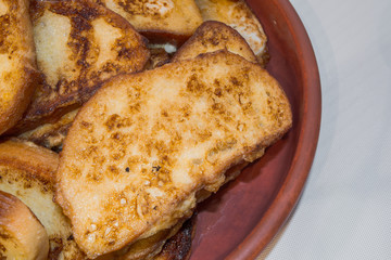 Pieces of toasted bread prepared on the pan. Toasts on the plate.