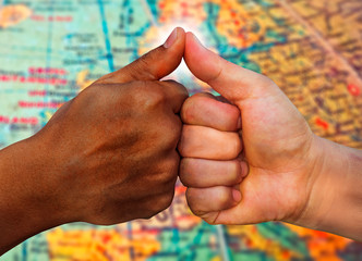 multiracial hands together African American and Caucasian touching thumbs as team in promise sign...