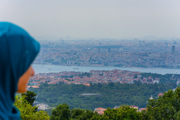 Girl is looking to the city of Istanbul from the Camlica