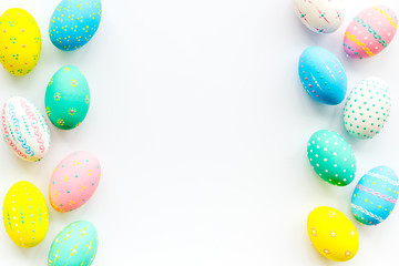 Decorated Easter eggs on white background border copy space