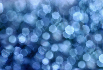 abstract blurred glowing light particles of shades of light blue