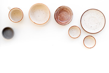 Ceramic tableware pattern. Empty plates and mugs on white background top view copy space