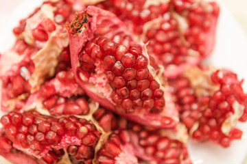 Pomegranate on a white background. Natural fruit. Red fruit. Pomegranate on the table.