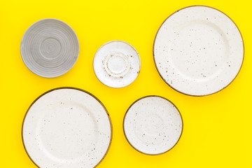 Mockup with plates. Empty ceramic plates on yellow background top view