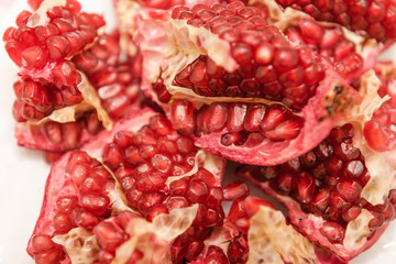 Pomegranate on a white background. Natural fruit. Red fruit. Pomegranate on the table.