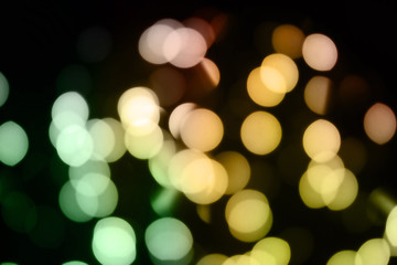 Obraz premium abstract blurred glowing light particles of shades of green and yellow