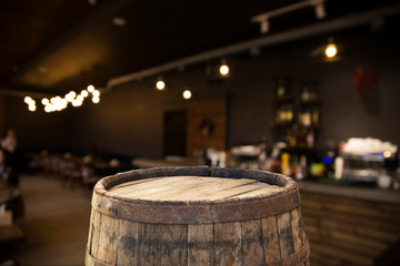 Beer barrel with beer glasses on a wooden table. The dark brown background.