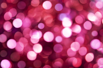 abstract blurred glowing light particles of shades of pink and white