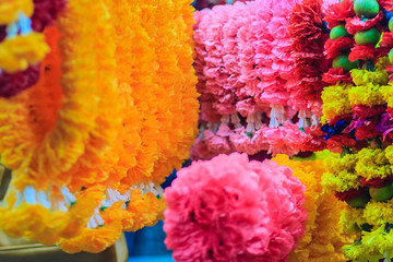 Colorful marigold flower garlands for hindu religious ceremony. Garland of indians for worship goddess in the florist shop nearby Sri Maha Mariamman Temple, Silom, Bangkok, Thailand.