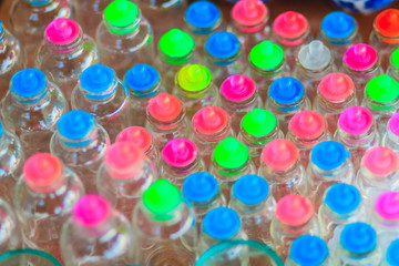 Glass jars with colorful lids for sale at the street market in Bangkok
