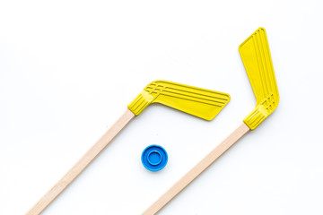 Ice hockey stick and puck on white background top view copy space