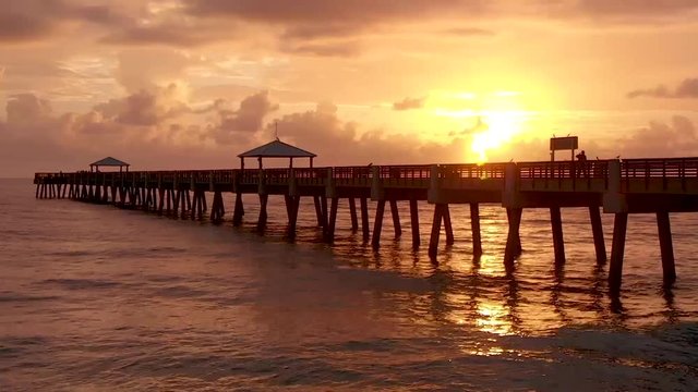 Low to High Aerial of Sunrise at Juno Beach Florida Pier