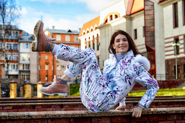 Girl in a beautiful white jumpsuit in the city