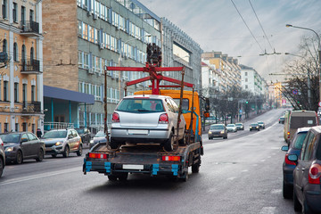 Towing of vehicle on forklift truck. Tow truck with equipped hydraulic manipulator for emergency...