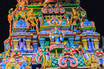 Colorful night view of indian gods sculpture at Sri Maha Mariamman Temple, also known as Maha Uma Devi temple, the public hindu temple in Silom, Bangkok, Thailand. It known as Wat Khaek Silom.