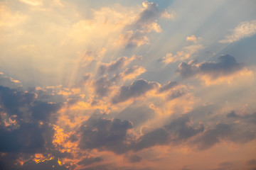 Blue and orange sunset sky with rays of sun. Natural landscape for background