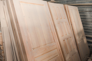Fototapeta na wymiar Wooden doors in stock. A lot of wooden doors. Joinery.