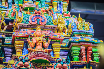 Colorful night view of indian gods sculpture at Sri Maha Mariamman Temple, also known as Maha Uma Devi temple, the public hindu temple in Silom, Bangkok, Thailand. It known as Wat Khaek Silom.