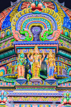 Colorful night view of indian gods sculpture at Sri Maha Mariamman Temple, also known as Maha Uma Devi temple, the public hindu temple in Silom, Bangkok, Thailand. It known as Wat Khaek Silom.