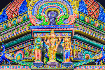 Colorful night view of indian gods sculpture at Sri Maha Mariamman Temple, also known as Maha Uma Devi temple, the public hindu temple in Silom, Bangkok, Thailand. It known as Wat Khaek Silom.