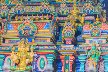 Colorful night view of indian gods sculpture at Sri Maha Mariamman Temple, also known as Maha Uma Devi temple, the public hindu temple in Silom, Bangkok, Thailand. It known as Wat Khaek Silom.