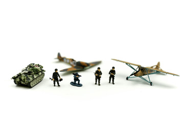 Miniature people : team soldier standing together with army tank and aircraft air combat using for...