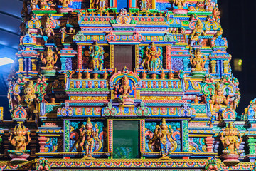 Colorful night view of indian gods sculpture at Sri Maha Mariamman Temple, also known as Maha Uma Devi temple, the public hindu temple in Silom, Bangkok, Thailand. It known as Wat Khaek Silom.