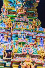 Colorful night view of indian gods sculpture at Sri Maha Mariamman Temple, also known as Maha Uma Devi temple, the public hindu temple in Silom, Bangkok, Thailand. It known as Wat Khaek Silom.