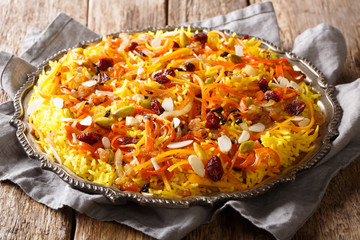 Iranian wedding pilaf Javaher Polow or jeweled rice close-up on a plate. horizontal