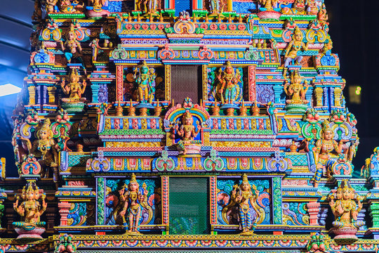Colorful night view of indian gods sculpture at Sri Maha Mariamman Temple, also known as Maha Uma Devi temple, the public hindu temple in Silom, Bangkok, Thailand. It known as Wat Khaek Silom.