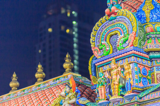 Colorful night view of indian gods sculpture at Sri Maha Mariamman Temple, also known as Maha Uma Devi temple, the public hindu temple in Silom, Bangkok, Thailand. It known as Wat Khaek Silom.