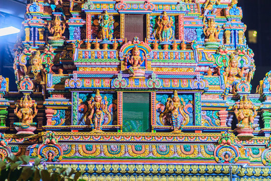 Colorful night view of indian gods sculpture at Sri Maha Mariamman Temple, also known as Maha Uma Devi temple, the public hindu temple in Silom, Bangkok, Thailand. It known as Wat Khaek Silom.