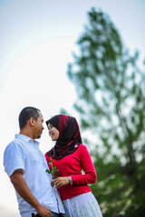 people, leisure and lifestyle concept - happy lovely young couple at the park together enjoy the day 