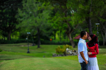 holidays, vacation, love and friendship concept - smiling teen couple in sunglasses having fun in summer park 