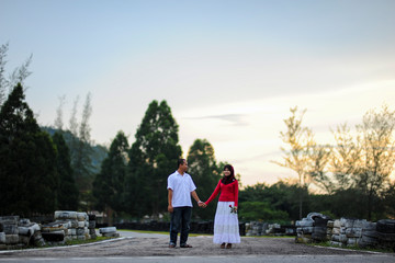 Potrait of happy young couple enjoying a day in park together.