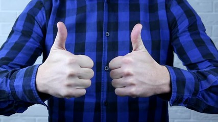 The hand of a man shows a class. The man shows that he is all right.