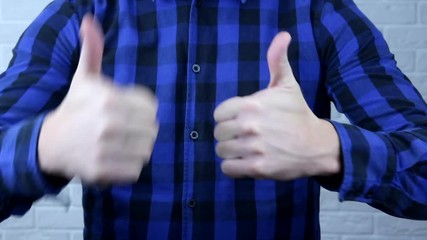 The hand of a man shows a class. The man shows that he is all right.