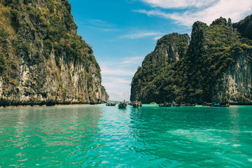 Naklejka na ściany i meble view of iconic tropical turquoise water Pileh Lagoon surrounded by limestone cliffs, Phi Phi islands, Thailand 