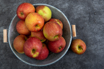 top view of delicious red apples in old metal washtub