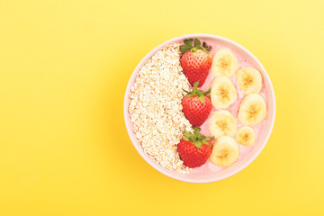 Smoothie bowl on yellow background