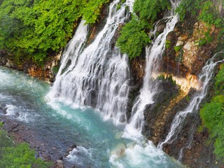 Fototapeta na wymiar Beautiful natural waterfall named “Shirahige waterfalls” in Biei, Hokkaido, Japan.