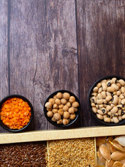 bean seeds, lentil, peas on wooden table, healthy rich with fiber food, food rich in vitamin A, E, B, K, Mg calcium, phosphorus, iron
