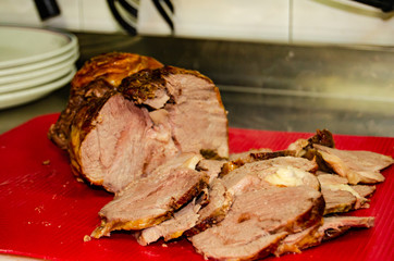 slow cooked beef sliced on th red chopping board