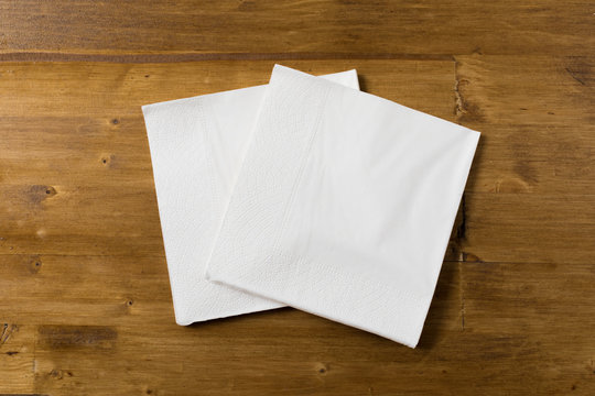 white paper napkin on wooden background.
