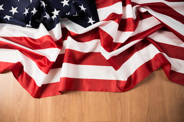 Flag of United States on a wooden table background.