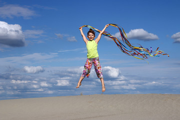 happy little girl jumping summer season