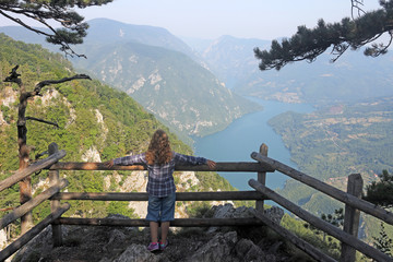 Fototapeta na wymiar little girl enjoy in nature viewpoint Banjska stena Tara mountain