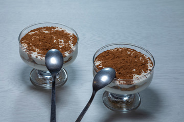 Curd dessert Tiramisu in a glass dish.