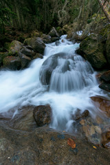 river in the mountains. mountainous area. photo on a long exposure, cloudy day.  waterfalls in the mountains in the forest