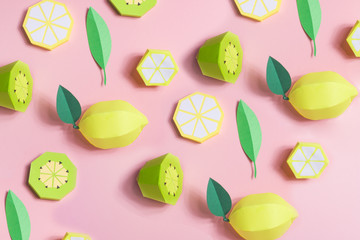 Fruit made of paper. Pink background. There's room for writing. Tropics. Flat lay. Kiwi, lemon.